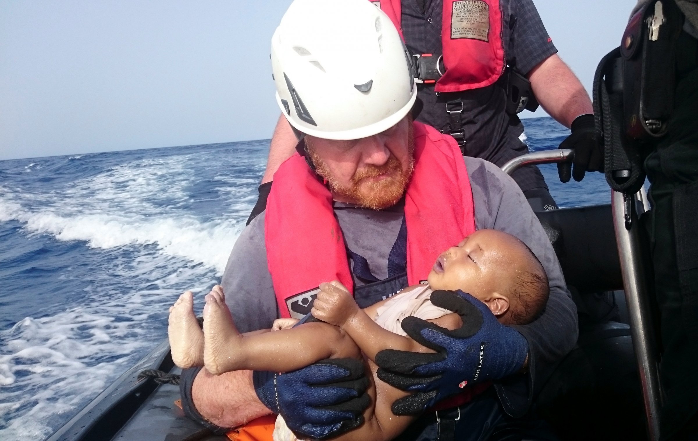 Sea Eye Volunteer Holds Drowned Refugee Baby